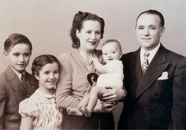 Family in 1947 standing holding baby.